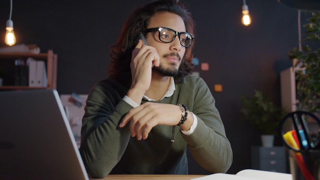 Press coordinator wearing a headset answering calls at a desk